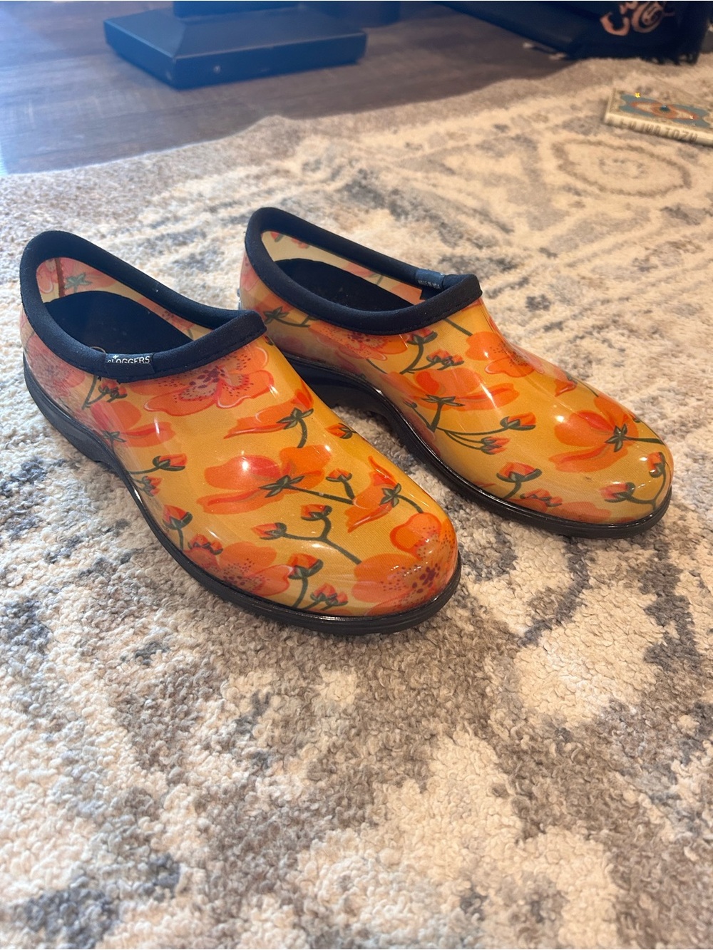 Sloggers waterproof garden clogs featuring a vibrant orange poppy pattern size 9